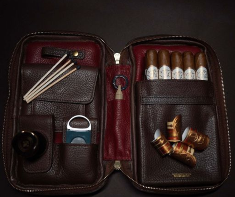 A selection of essential cigar accessories including cutters, lighters, and a humidor