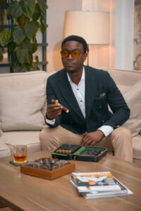 Cigar Etiquette' - a man in a suit with a cigar and whiskey, showcasing the cultured lifestyle of a cigar enthusiast