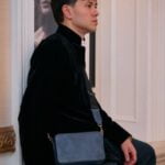 "Man in a sleek suit carrying the Aficionado Elegance Italian leather crossbody bag.