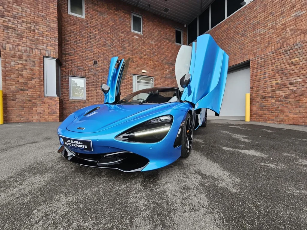 Blue McLaren supercar with scissor doors open
